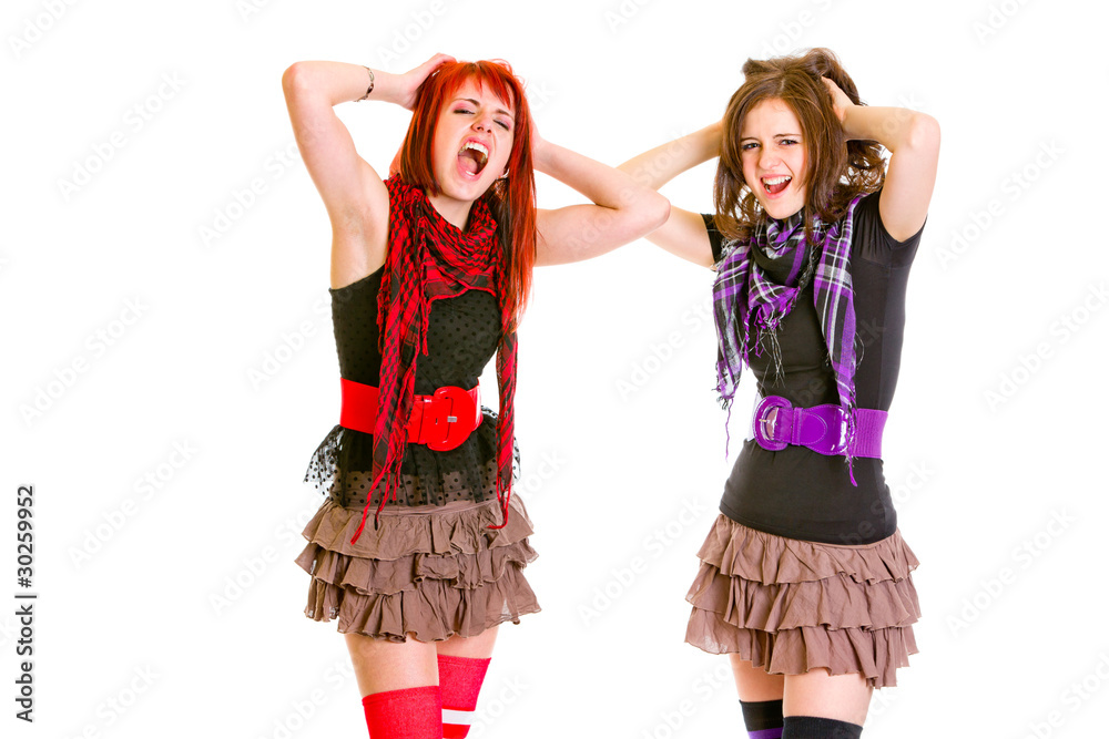 Two cute girlfriends with hands near head unhappily crying Two cute girlfriends with hands near head unhappily crying