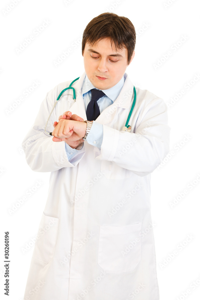 Concentrated medical doctor looking at clock Concentrated medical doctor looking at clock