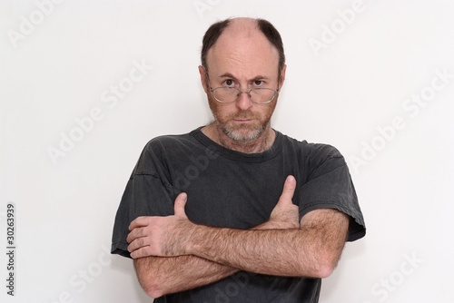 Fotografi Unshaved disheveled man in spectacles frowning sullenly