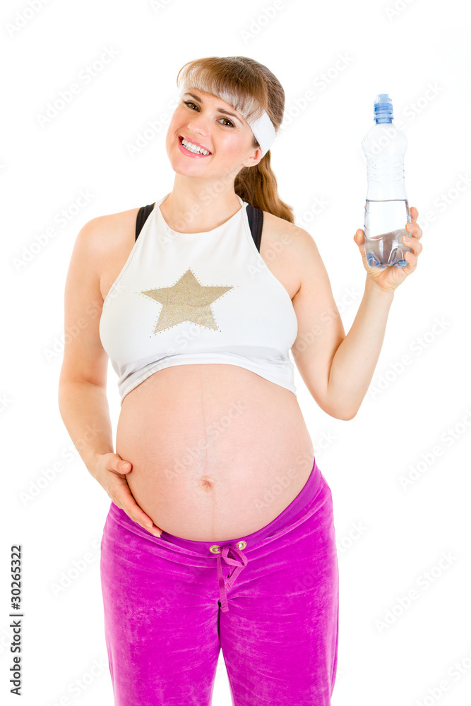 Smiling beautiful pregnant female holding bottle of water. Smiling beautiful pregnant female holding bottle of water.