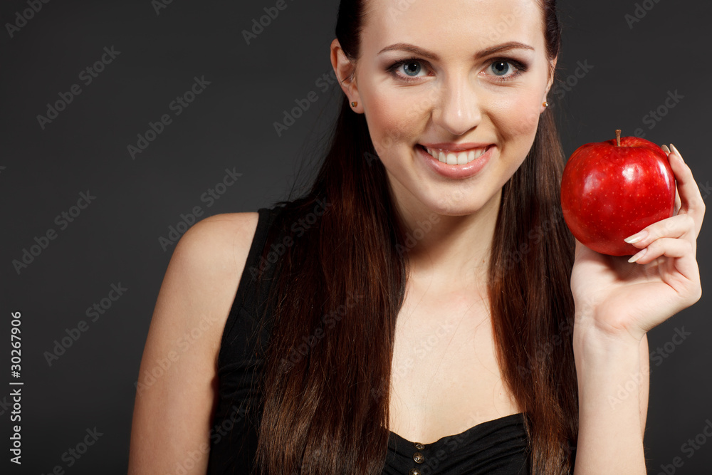 Young elegant female in black holding red apple Young elegant female in black holding red apple