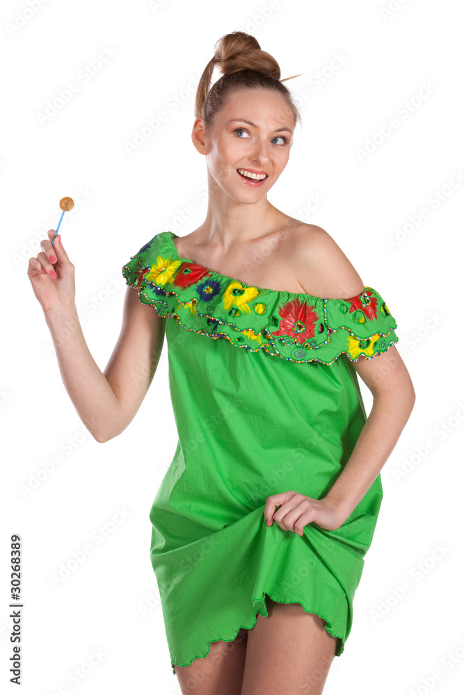 Young joyful female in greed summer dress with candy Young joyful female in greed summer dress with candy
