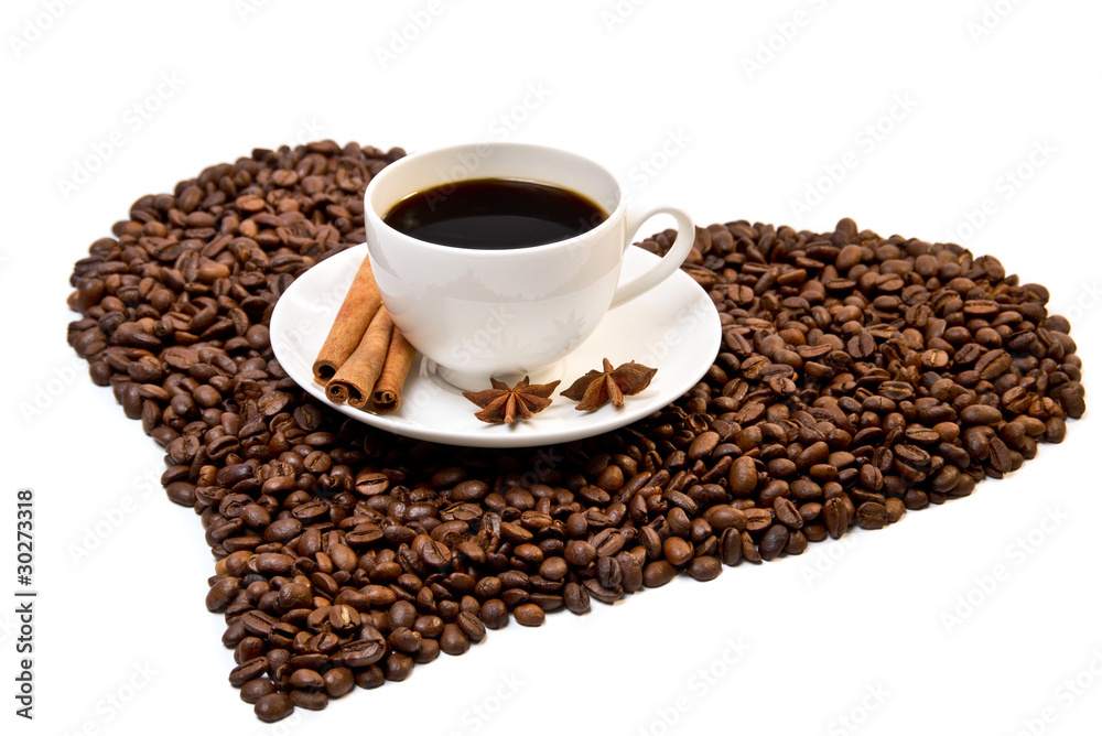 White cup of coffee on heart shaped coffee beans