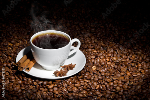 White cup of hot coffee on coffee beans © ChaosMaker