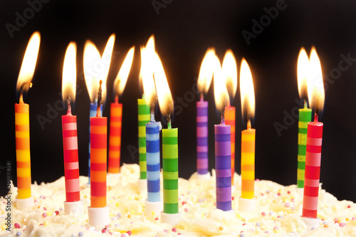 birthday cake and candles on black background