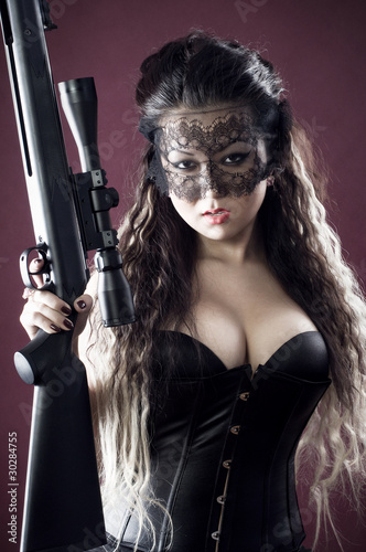 Masked beautiful asian woman with rifle