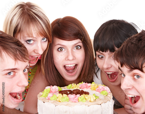 Group of happy young people eat cake.