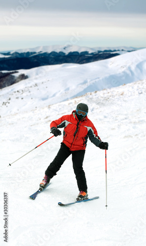 Skier man in snow-covered mountains
