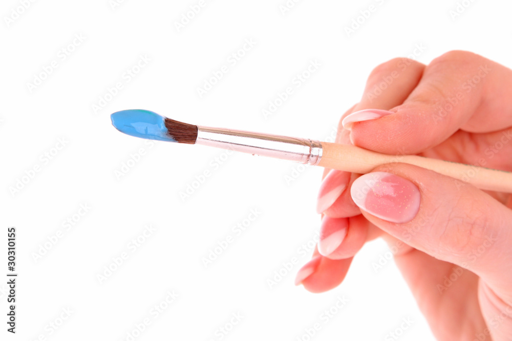 Paint brush in hand isolated on white