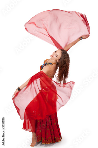 Young belly dancer turning with veil sleeves