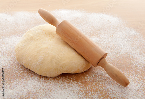 Pizza dough with rolling pin photo