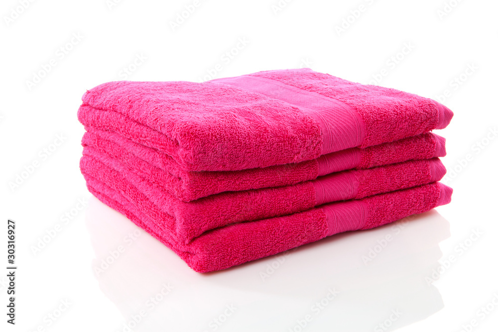 pile of pink towels over white background