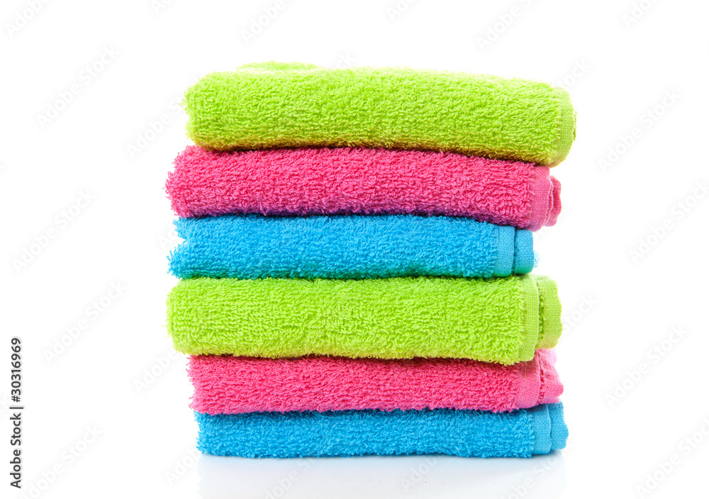 pile of colorful towels over white background pile of colorful towels over white background