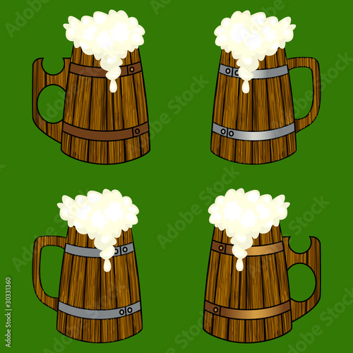 Four wooden beer mugs with the overflowing foam