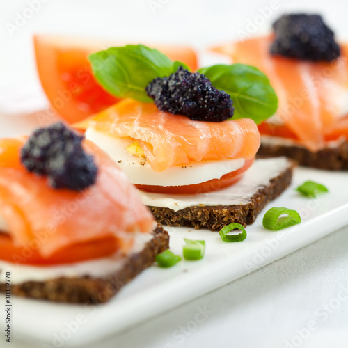 Delicious canapes with salmon and caviar