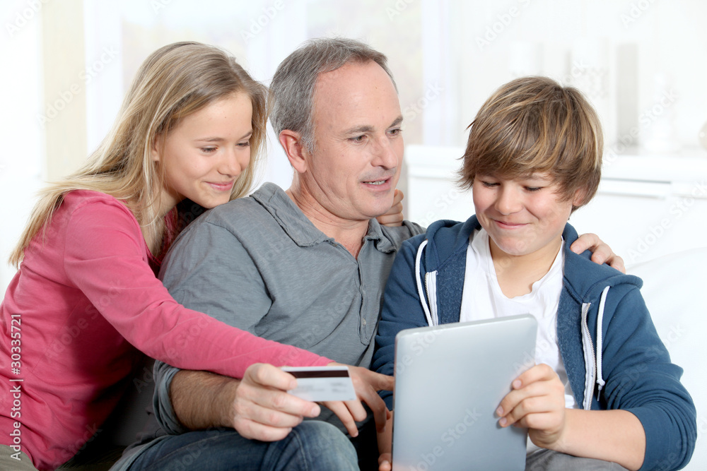 Father and children doing online shopping at home Father and children doing online shopping at home