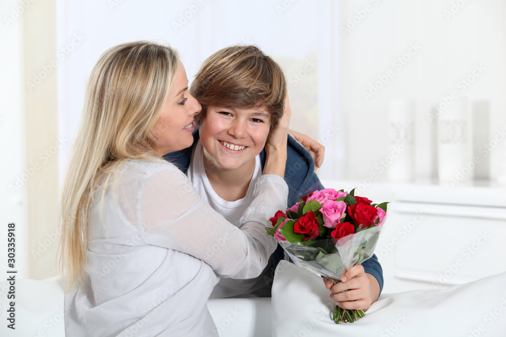 Son offering bunch flowers on mother's birthday Son offering bunch flowers on mother's birthday