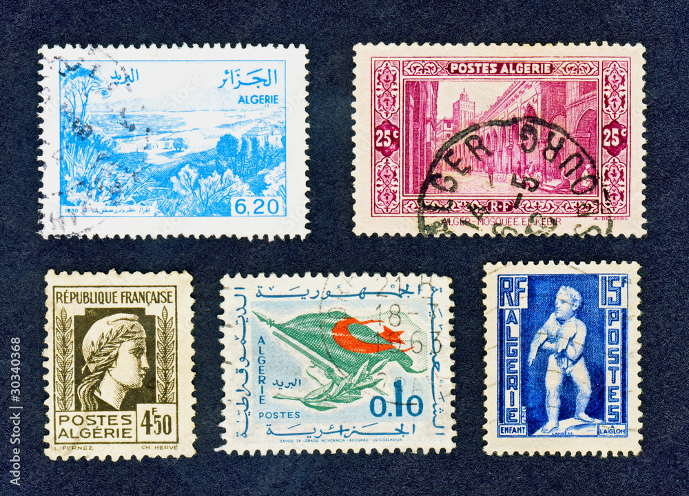 Close up of old cancelled Algerian stamps on black Close up of old cancelled Algerian stamps on black