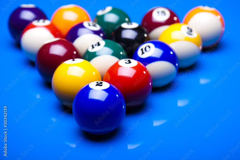 Pool game balls against a blue Pool game balls against a blue