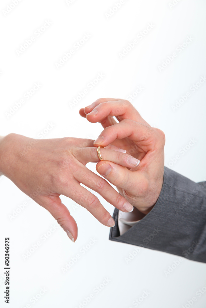 Closeup of bride and groom exchanging wedding rings Closeup of bride and groom exchanging wedding rings