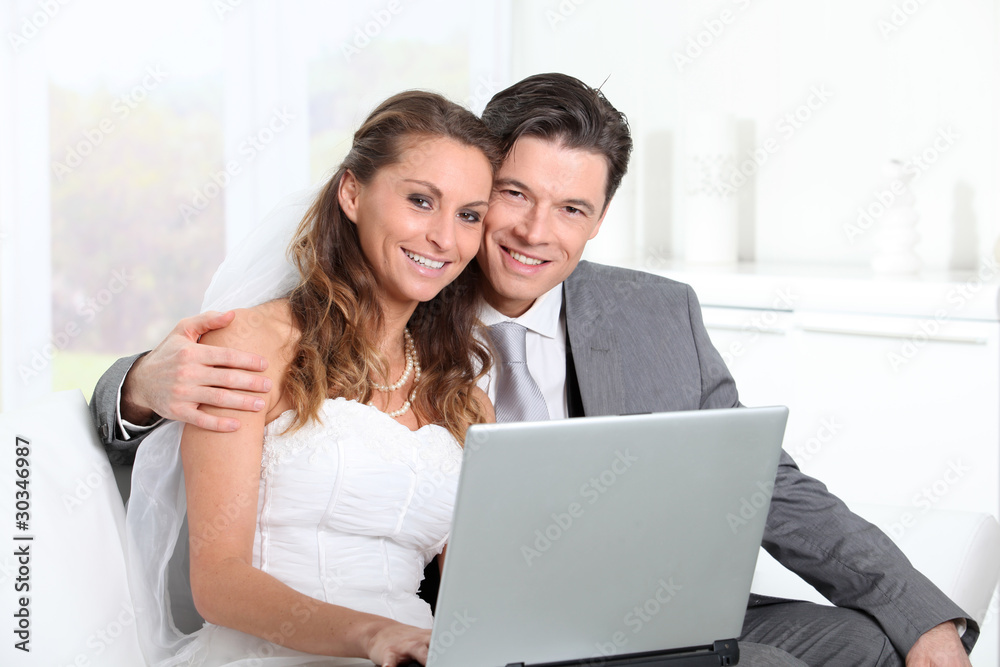 Bride and groom surfing on internet Bride and groom surfing on internet