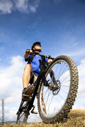 Fototapeta Naklejka Na Ścianę i Meble -  Mountain Biker and blue sky background