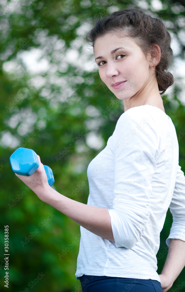 woman doing exercise with dumbbell woman doing exercise with dumbbell