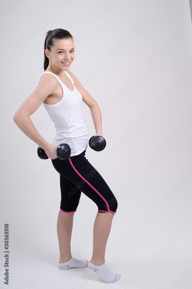 attractive female exercising with dumbbells attractive female exercising with dumbbells