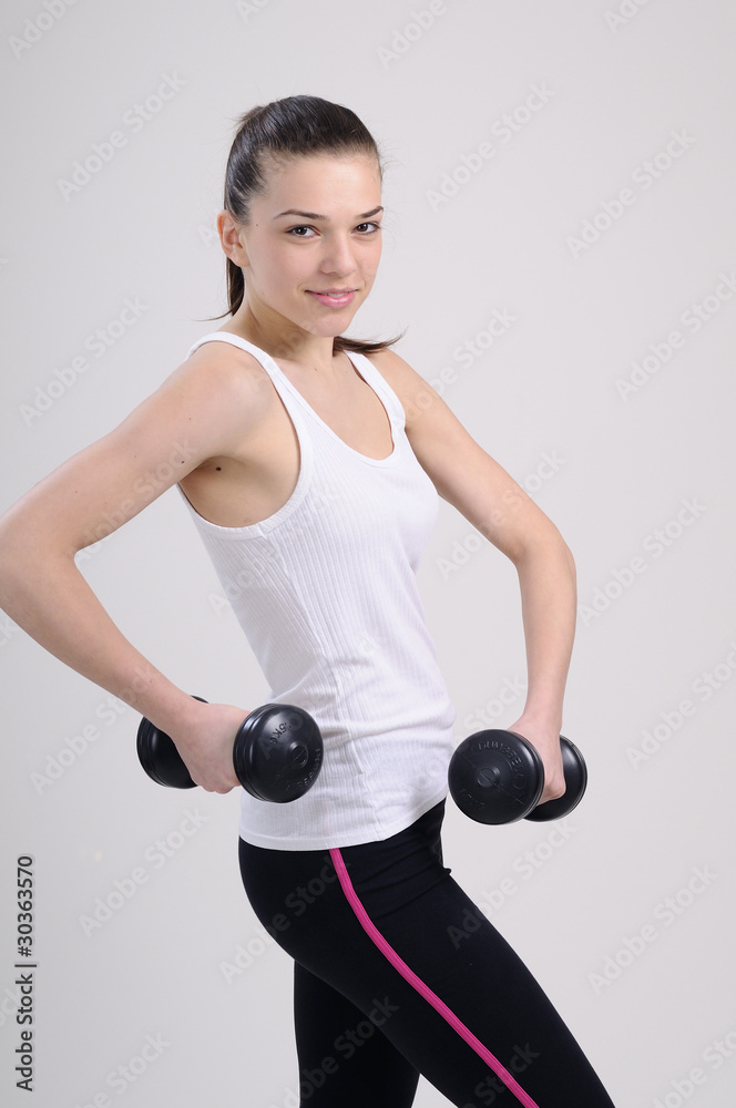 girl practicing bodybuilding with dumbbell girl practicing bodybuilding with dumbbell