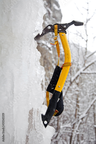 Climbing ice ax in the white ice