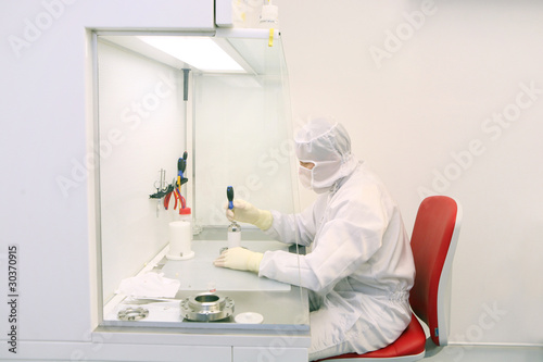 technician working in a clean room in laboratory