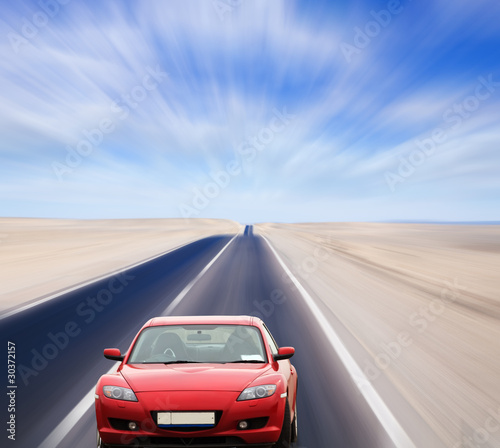 Red car on desert road