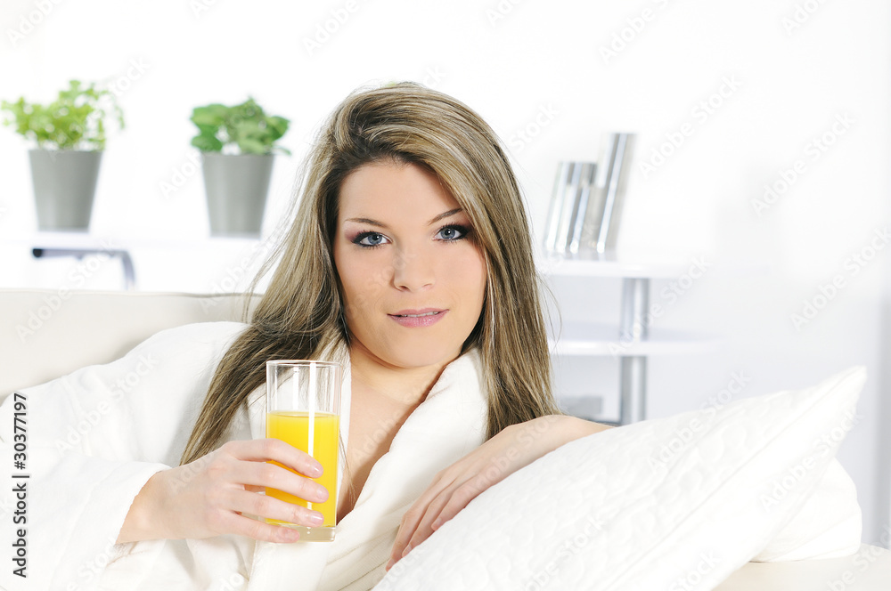 Beautiful blond woman relaxing at home whith an orange juice Beautiful blond woman relaxing at home whith an orange juice
