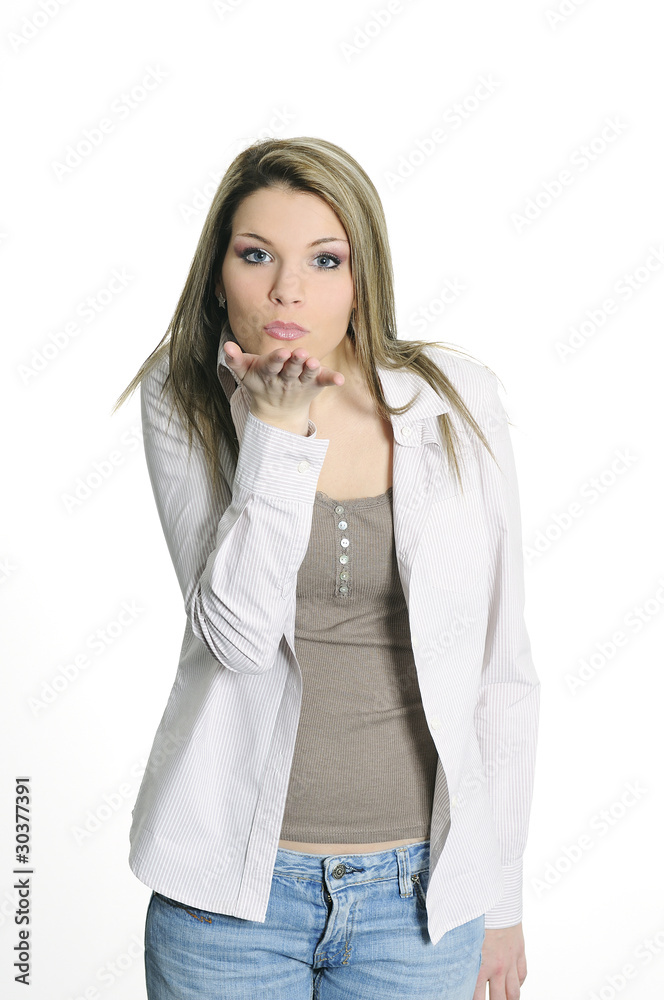 young woman in jeans sending a kiss blowing on his hands young woman in jeans sending a kiss blowing on his hands