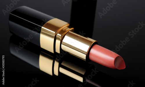 Luxury pink lipstick on black background. make-up