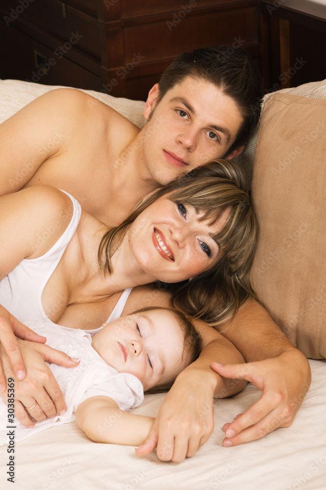 Happy young family relaxing at home Happy young family relaxing at home