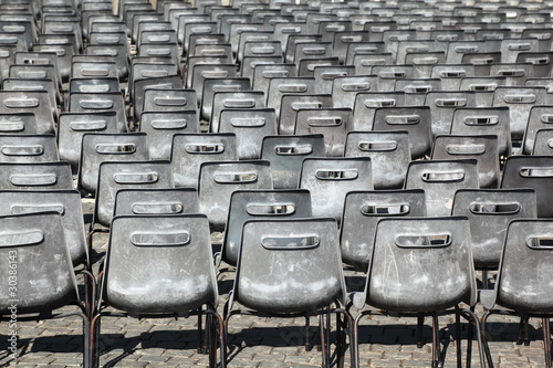 Many rows of gray  plastic chairs outdoor