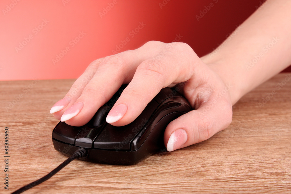 Mouse in hand on wooden table Mouse in hand on wooden table
