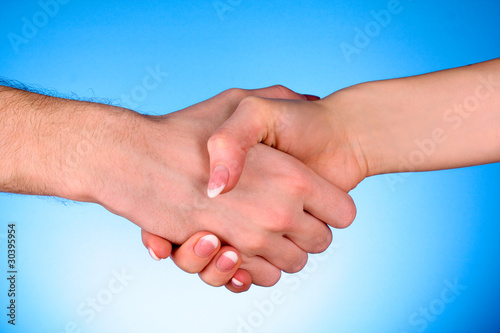 handshake between man and woman on blue background