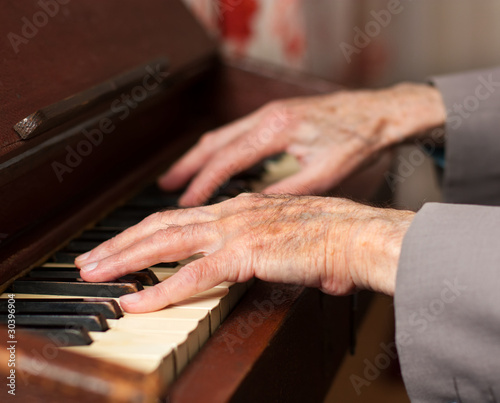 Hands playing a harmonium