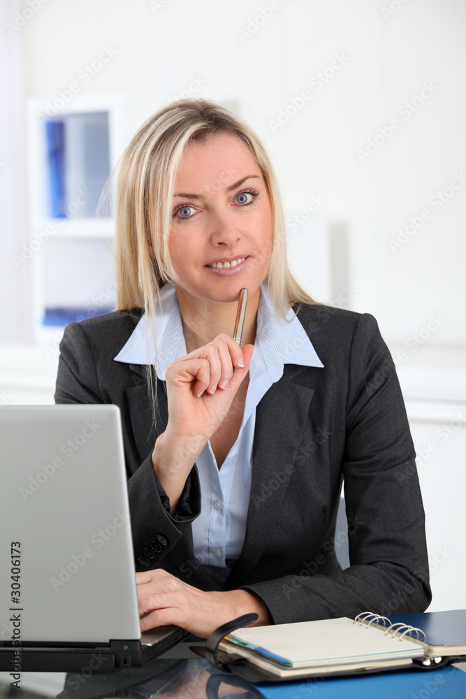 Businesswoman in the office with laptop computer Businesswoman in the office with laptop computer