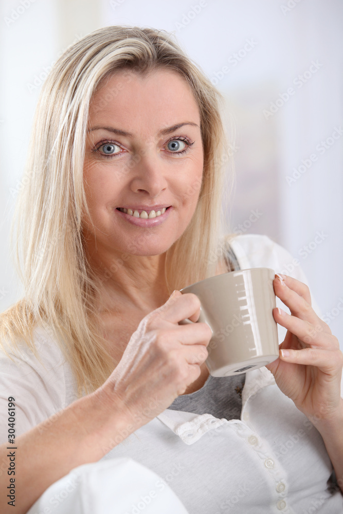 Portrait of beautiful blond woman drinking tea Portrait of beautiful blond woman drinking tea
