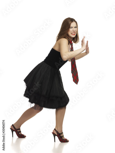 woman in little black dress pushing imaginary barrier