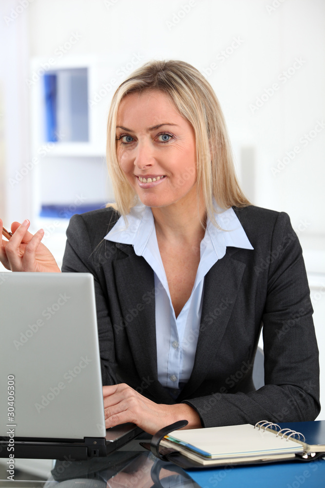 Businesswoman in the office with laptop computer Businesswoman in the office with laptop computer