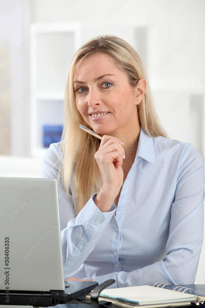 Beautiful blond woman working in the office Beautiful blond woman working in the office