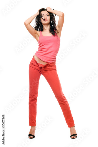 Sexy playful young brunette in a red jeans © Sergey Sukhorukov