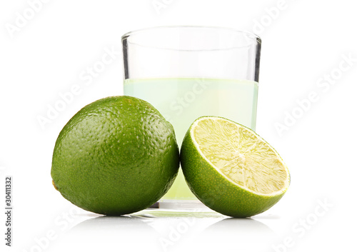 Glass of lime juice and lime fruits with slices isolated © Serhiy Shullye