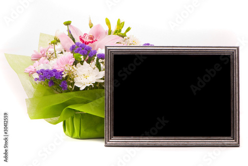 Beautiful bouquet and silver frame on a white