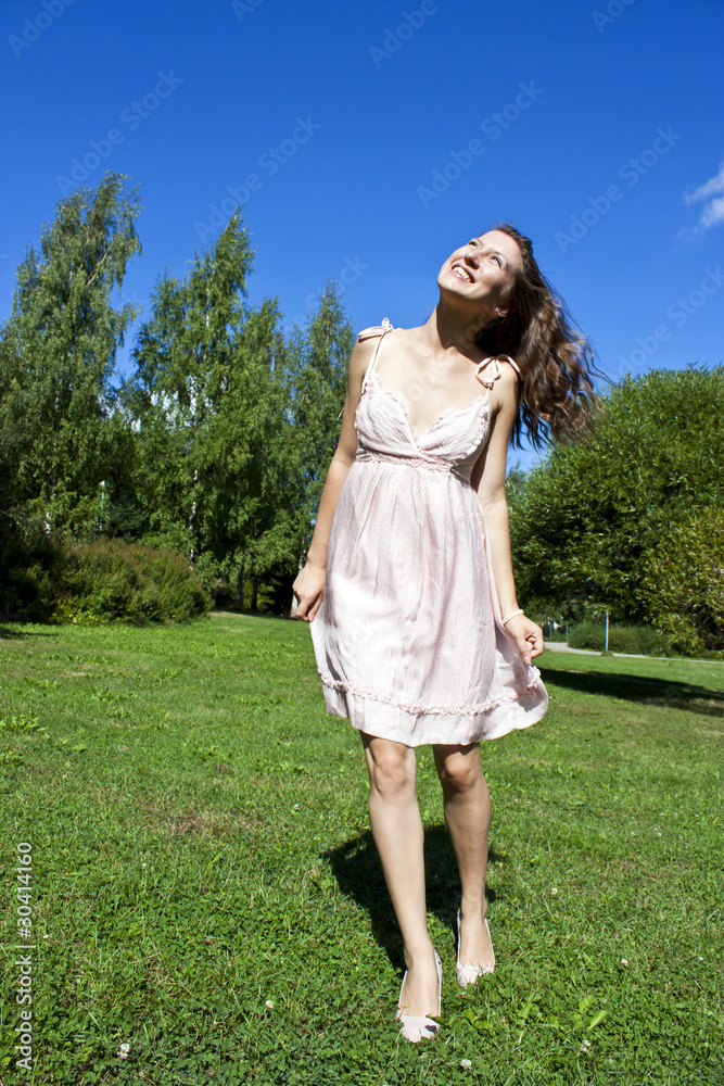 Beautiful young happy woman under blue sky. Beautiful young happy woman under blue sky.