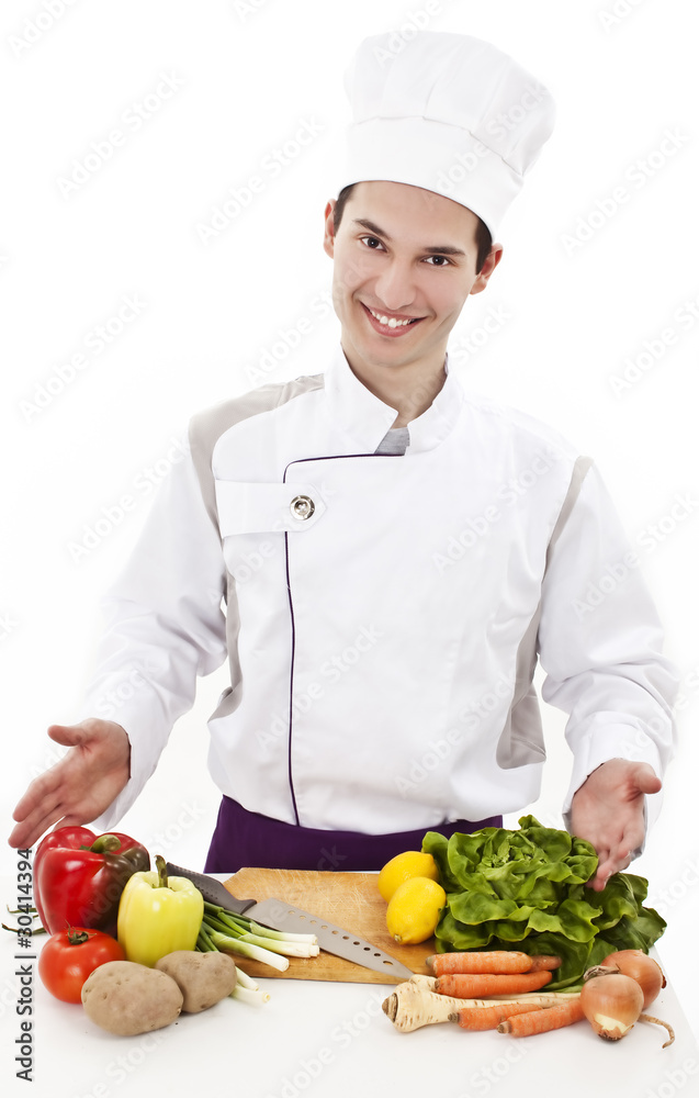 Young attractive man, chef showing variety of fresh vegetables Young attractive man, chef showing variety of fresh vegetables
